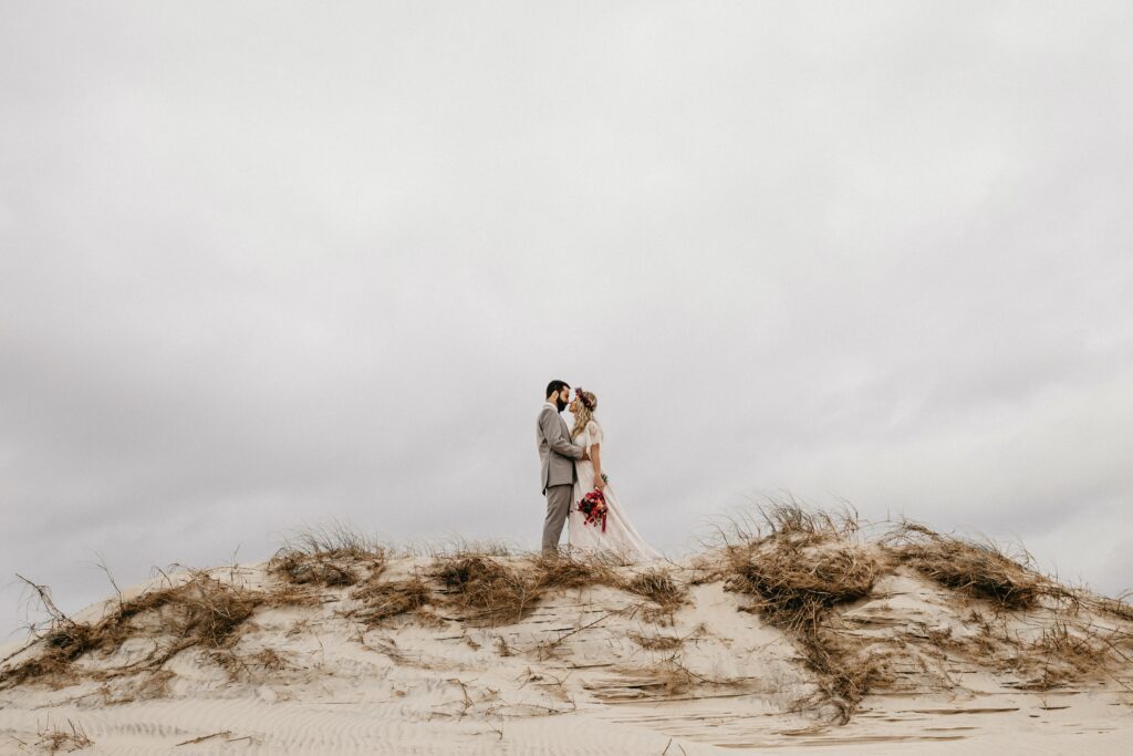 bride and groom on sand